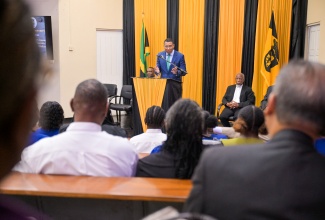 Prime Minister, Dr. the Most Hon. Andrew Holness, addresses students and faculty members of The Mico University College during a visit to the institution on Teachers’ Day, Wednesday (May 7). He is flanked by the institution’s President, Dr. Asburn Pinnock (left), and Chairman, Reverend Professor Veront Satchell.