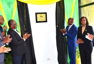 Minister of Labour and Social Security, Hon. Pearnel Charles Jr. (third right), and Chairman, Industrial Disputes Tribunal (IDT), Errol Miller (third left), unveil a 50th anniversary commemorative plaque in recognition of the entity’s contribution to Jamaica’s labour relations framework. The ceremony was held at the IDT