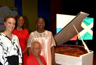 Minister of Foreign Affairs and Foreign Trade, Hon. Kamina Johnson Smith (left) shares a photo opportunity with Permanent Secretary in the Ministry of Foreign Affairs and Foreign Trade, Ambassador Sheila Sealy Monteith (second left), Ambassador of the Republic of Colombia to Jamaica, Her Excellency Emiliana Bernard Stephenson (right) and Colombian Pianist, Teresita Gomez (seated) during the celebration of the 60th anniversary of diplomatic relations between Colombia and Jamaica at the Courtleigh Auditorium, Kingston, on Thursday (June 5).