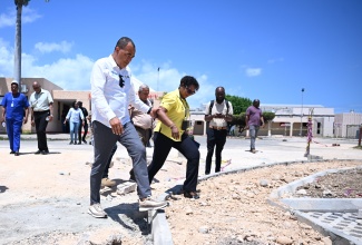 Minister of Health and Wellness, Dr. the Hon. Christopher Tufton (left), and Chief Executive Officer at the May Pen Hospital in Clarendon, Eugena Clarke-James (right), tour the hospital on Friday (May 30). The tour is part of the Ministry’s Health System Strengthening Programme and Operation Refresh, which focuses on upgrading hospitals and community health centres to enhance service delivery and improve patient care.