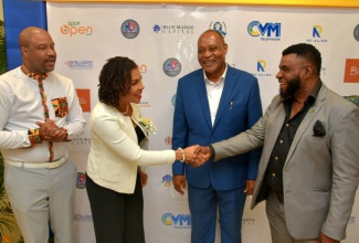 Minister without Portfolio in the Office of the Prime Minister with Responsibility for Efficiency, Innovation and Digital Transformation, Senator the Hon. Ambassador Audrey Marks (second left), is greeted by President of the Small Business Association, Garnett Reid (right), at the Realign Business & Investment Conference, held at The Jamaica Pegasus hotel in New Kingston on June 25. Observing are Chairman of Entrepreneurial Partners Limited, Garfield Daley (second right), and Chief Executive Officer of Blue Mahoe Capital, David Mullings. Ambassador Marks delivered the main address.

