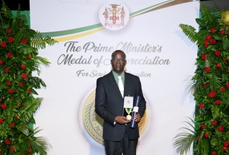 Faculty Dean at Bethlehem Moravian College in St. Elizabeth, Isaac Onywere, is a 2024 recipient of the Prime Minister's Medal of Appreciation for Service to Education, which he displays here, at Jamaica House on May 28.

