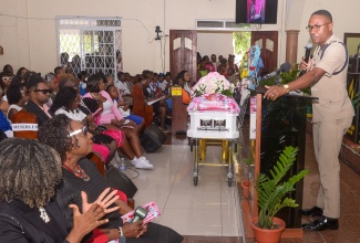 Head of the Area 5 Police, Assistant Commissioner of Police (ACP) Christopher Phillips, pays tribute to Kelsey Ferrigon during her thanksgiving service on Monday (June 9). The ceremony was held at the Spanish Town Seventh-day Adventist Church in St. Catherine.

