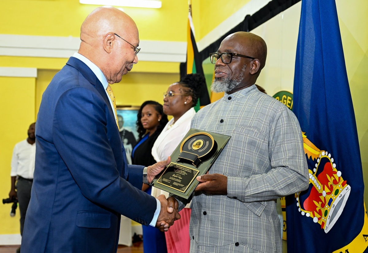 Governor-General, His Excellency the Most Hon. Sir Patrick Allen (left), presents Jamaica Information Service (JIS) Senior Reporter, Garfield Angus, with his award at the 2025 Governor-General’s Achievement Awards (GGAA) ceremony, held at King’s House on Thursday (June 26). Mr. Angus was the St. Catherine awardee in the over 35 age category. In the background are the St. Catherine awardees for the 18-24 years category, Shamoi Brown (second left) and in the 25 to 35 years category, Sherika Perkins.

