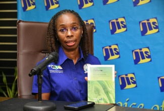 Manager of the Pollution Prevention Branch at the National Environment and Planning Agency (NEPA), Bethune Morgan, displays a copy of the Basel Convention on the Control of Transboundary Movements of Hazardous Wastes and their Disposal, at a JIS Think Tank, on June 11. 

