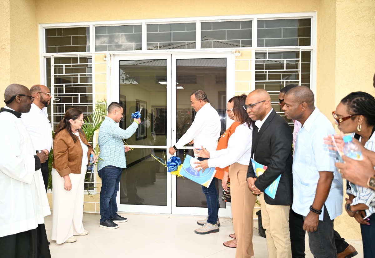 Health and Wellness Minister, Dr. the Hon. Christopher Tufton (seventh right), and Minister without Portfolio in the Ministry of Economic Growth and Job Creation, Hon. Matthew Samuda (fourth left), are joined by other stakeholders, as they cut the ribbon to mark the official opening of the new $383 million St. Ann Health Department Administrative Building on Friday (June 6).