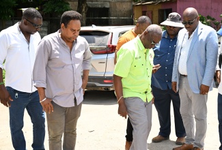 Minister of Local Government and Community Development, Hon. Desmond McKenzie (third left), tours the temporary site for the Negril Fruit and Vegetable Market in Westmoreland during a visit to the parish on Friday (June 20). He is joined by Chairman of the Westmoreland Municipal Corporation and Mayor of Savanna-la-Mar, Councillor Danree Delancy (right); Chief Technical Director in the Ministry, Dwight Wilson (second left) and other stakeholders.