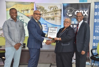 Chief Executive Officer of the Kingston and St. Andrew Municipal Corporation (KSAMC), Robert Hill (second left), and Director of the Jamaica Stock Exchange (JSE), Dr. Marlene Street Forrest (second right), display the signed Memorandum of Understanding (MOU) formalising a partnership between the entities to beautify, maintain, and secure a part of Gold Street in downtown Kingston. Sharing the moment are Mayor of Kingston, Councillor Andrew Swaby (left), and Group Business Development Manager, JSE, André Gooden. The signing ceremony was held on Monday (June 23) at the JSE Headquarters on Harbour Street in Kingston.


