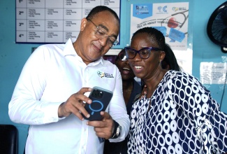 Minister of Health and Wellness, Dr. the Hon. Christopher Tufton (left), shows Parish Manager at Westmoreland Public Health Services, Novlin Little (right), and Medical Officer of Health for Westmoreland, Dr. Marcia Graham (centre) plans for the expansion of the Little London Health Centre. Occasion was a tour of the facility by the Minister on Tuesday (June 3).