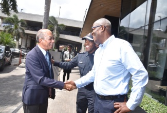 Deputy Prime Minister and Minister of National Security, Hon. Dr. Horace Chang (left) greets former Police Commissioner and Acting Managing Director of the Jamaica Urban Transit Company (JUTC) Owen Ellington (right) and Commissioner of Police, Dr. Kevin Blake (second right) at the launch of the second staging of the Jamaica Constabulary Force's Transformations People Quality Technology Expo (Expo 2.0) and Mensa Distinguished Lecture at the AC Marriott Hotel in Kingston on Friday (June 6). Expo 2.0 will be held at the National Arena in Kingston and Montego Bay Community College in St. James on June 19-22.