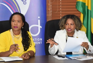 Minister of Education, Skills, Youth and Information, Senator Dr. the Hon. Dana Morris Dixon (right), speaks during Friday’s (June 20) Primary Exit Profile (PEP) Press Conference, at the Ministry’s Heroes’ Circle offices in Kingston. At left is  Permanent Secretary in the Ministry, Dr. Kasan Troupe.