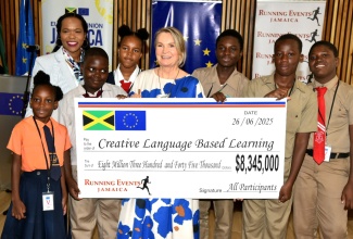 Head of the European Union (EU) Delegation to Jamaica, Her Excellency Dr. Erja Eskola (fourth right), presents a cheque for $8,345,000 to the Creative Language-Based Learning Foundation in support of summer literacy camps during a handover ceremony on June 26. The funds were raised through the EU-JA 5K and 10K Run/Walk, which held in March in downtown Kingston, in partnership with the Jamaican Government and Running Events Jamaica. The presentation was made at the EU Delegation office in Kingston. Also participating (from left) are Edward Seaga Primary School student, Kashae Matthews; Permanent Secretary in the Ministry of Education, Skills, Youth and Information, Dr. Kasan Troupe; Greenwich Primary student, Rajaun Drummonds; Cockburn Gardens Primary student, Tyeisha Lindsay; Whitfield Primary student, Devana Thomas; Calabar Primary student, Carlan Malcolm, and Cockburn Gardens Primary student, Jayden Hemmings.