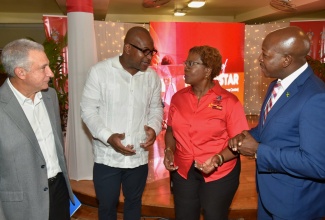 Minister of Labour and Social Security, Hon. Pearnel Charles Jr (right), listens as Pro-Vice Chancellor and Principal, University of the West Indies(UWI) Mona, Professor Densil Williams (second left), shares a point with Director of the university’s Short Term Advancement and Resource Centre (UWI STAR), Dr. Olivene Burke, during the recent launch of the initiative at the Mona campus in St. Andrew. Also sharing in the discussion is President, Private Sector Organisation of Jamaica (PSOJ), Metry Seaga.