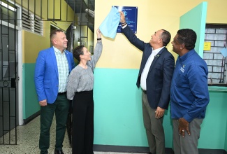 Minister of Health and Wellness, Dr. the Hon. Christopher Tufton (second right), unveils a plaque at the adoption ceremony for the Kenneth Standard Health Centre, which is based at the University of the West Indies (UWI), Mona Campus, on June 19. Others pictured (from right) are Jamaica’s Consul General (CG) to Miami, Oliver Mair; Minister of Foreign Affairs and Foreign Trade, Senator the Hon. Kamina Johnson Smith, and Executive Director of the Ministry of Health and Wellness’ Health for Life and Wellness Foundation, Courtney Cephas.