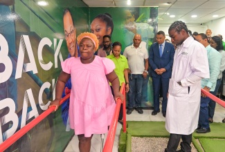 Prime Minister, Dr. the Most Hon. Andrew Holness (second right), looks on as New Limb, New Life beneficiary, Dalvarine Bruce Pearce (left), tries out her prosthetic limb. Also observing are Physiotherapist, Adria Sterling-Campbell (second left); Member of Parliament for St. Thomas Western, Hon. James Robertson (fourth left); and Prosthetic Technician, Jerome Walters Prosthetic Technician, Jerome Walters (right). Occasion was a visit by the Prime Minister to the Surgix Prosthetics Clinic at the Sir John Golding Rehabilitation Centre in St. Andrew on Wednesday (June 11).


