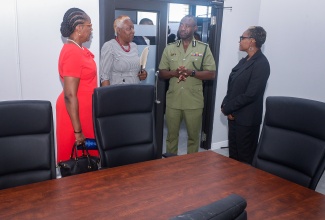 State Minister in the Ministry of National Security, Hon. Juliet Cuthbert Flynn (right), listens to a comment from Commissioner of Corrections, Brigadier (Ret’d) Radgh Mason (second right), during a tour of the newly established DCS Recruitment and Training Centre on Friday (June 20), located on East Street in downtown Kingston. Others (from left) are Permanent Secretary in the Ministry of National Security, Ambassador Alison Stone Roofe (left), and Senior Director, Human Resource Management and Administration, Department of Correctional Services (DCS), Althea Davis.

