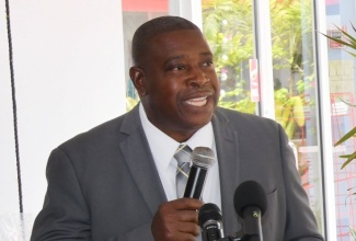 Head of the Public Safety and Traffic Enforcement Branch (PSTEB), Assistant Commissioner of Police, Dr. Gary McKenzie, addresses the recent launch of National Road Safety Month 2025, at Chambers Service Station in New Kingston.