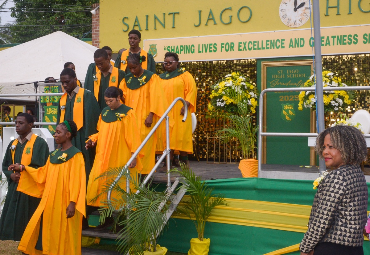 Minister of Education, Skills, Youth and Information, Senator Dr. the Hon. Dana Morris Dixon (right), looks on as members of St. Jago High School’s 2025 graduating class make their entrance. The school-leaving exercise was held on June 25 at the school’s campus on Monk Street in Spanish Town, St. Catherine.

