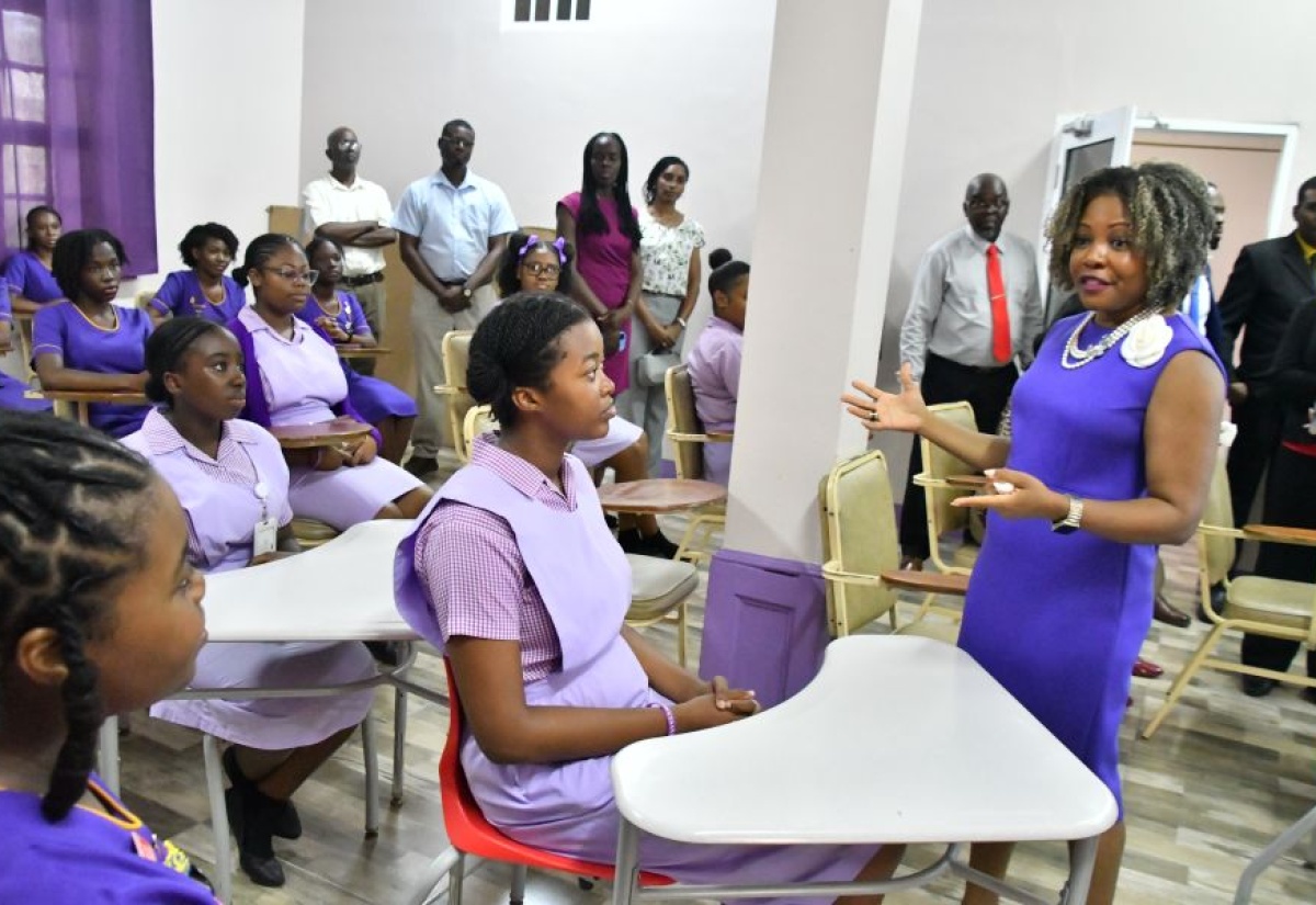 Minister of Education, Skills, Youth and Information, Senator Dr. the Hon. Dana Morris Dixon (right), interacts with students of St. Hilda’s Diocesan High School for Girls in St. Ann during a visit on Thursday (June 12). 

