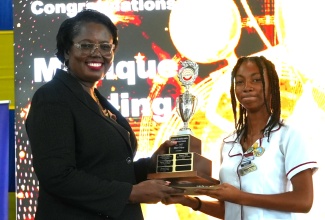Acting Chief Education Officer in the Ministry of Education, Skills, Youth and Information, Terry-Ann Thomas Gayle (left), presents Monique Holding of St. Andrew Technical High School with the award for Best TVET Student of the Year. Occasion was the 2025 National Technical and Vocational Education and Training (TVET) Quality Awards ceremony held recently at the Douglas Orane Auditorium, Wolmer’s Boys School in Kingston.

