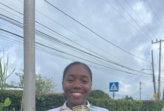 Grade 13 student at Marymount High School in St. Mary, Tanoya Garvey, poses with her first place trophy for Agri-Technology and Innovation in the 2025 Jamaica 4-H Clubs