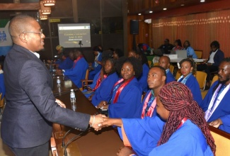 Minister of Agriculture, Fisheries and Mining, Hon. Floyd Green (left), engages with participants in the Rural Youth Economic Empowerment Programme (RYEEP) Builder, during a graduation ceremony on Friday (June 13) at the Jamaica Conference Centre in downtown Kingston.

