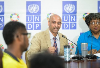 United Nations Development Programme (UNDP) Resident Representative for Jamaica, Kishan Khoday (left), addresses a panel during a Hurricane Ready & Resilient forum on Tuesday (June 10) at the UNDP Multi Country Office in Kingston. Listening is UNDP Communications Analyst, Gillian Scott.

