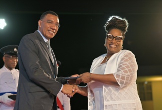 Prime Minister, Dr. the Most Hon. Andrew Holness, presents the Prime Minister’s Medal of Appreciation for Service to Education to Principal of Mount Alvernia High School in Montego Bay, St. James, Kayon Whyne, during a ceremony at Jamaica House in May.

