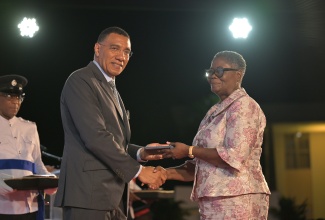 Prime Minister, Dr. the Most Hon. Andrew Holness, presents Vice Principal at the Denham Town High School in Kingston, Novette Nerida Christian, with an award for outstanding contribution to education. Occasion was the Prime Minister’s Medal of Appreciation for Service to Education awards ceremony held earlier this month on the lawns of Jamaica House.

