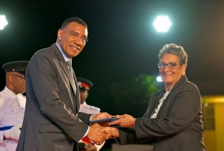 Executive Director and Founder of Liberty Academy at the Priory in Kingston, Suzanne Williams, collects the Prime Minister’s Medal of Appreciation for Service to Education from Prime Minister, Dr. the Most Hon. Andrew Holness, on May 28, at Jamaica House.

