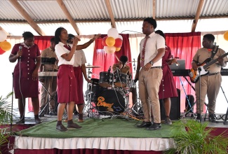 The Herbert Morrison Technical High School band gives a rousing performance during the recent handover of high-end studio equipment donated by International disc jockey Tayari “DJ Trauma” McIntosh, at the institution in St. James.

