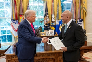 Jamaica’s Ambassador to the United States (US), His Excellency Major General (Ret’d) Antony Anderson (right), presents his Letters of Credence to US President, Donald Trump, during a brief ceremony held in the Oval Office at the White House on Thursday (July 24).