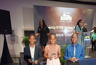Jamaica Public Service (JPS) Volunteers on Location to Serve (VOLTS) PEP Scholarship recipients (from left) Samuel Ridgard; Adrianna Willie, and Blake Wilson display their trophies during the JPS PowerUp Scholarship awards ceremony, held on Thursday (July 24), at The Jamaica Pegasus hotel in New Kingston. 