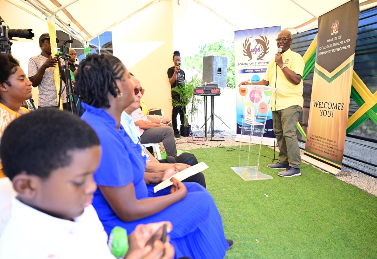 Minister of Local Government and Community Development, Hon. Desmond McKenzie (right), speaks during the handover ceremony for a furnished one-bedroom unit to Indigent Housing Programme beneficiary, Denise Chito, in Albion Meadows, St. Thomas, on Friday (July 25). The unit supplements a one-bedroom home Ms. Chito previously received under the New Social Housing Programme.