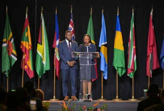 Jamaica's Caribbean Community (CARICOM) Youth Ambassadors, Odane Brooks (left) and Christal Parris-Campbell, give remarks at the 49th Regular Meeting of the Conference of Heads of Government of the Caribbean Community (CARICOM), at the Montego Bay Convention Centre in St. James, on Sunday (July 6). 

