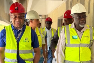 Custos of St. James, Bishop the Hon. Conrad Pitkin (right), and Regional Director of the Western Regional Health Authority (WRHA), St. Andrade Sinclair (left), tour sections of the Cornwall Regional Hospital redevelopment project in Montego Bay, St. James on Wednesday (July 24).  

 