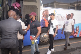 Minister of Labour and Social Security, Hon. Pearnel Charles Jr. (left), sends off workers departing the island to take up employment opportunities in North America. The departure ceremony was held on Tuesday (July 15) at the Ministry’s Overseas Employment Centre on East Street in downtown Kingston.