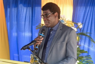 Deputy Commissioner of Corrections, Dr. Marc Thomas, addresses the recent Tamarind Farm Agricultural Day and Graduation Ceremony for inmates, in St. Catherine.

