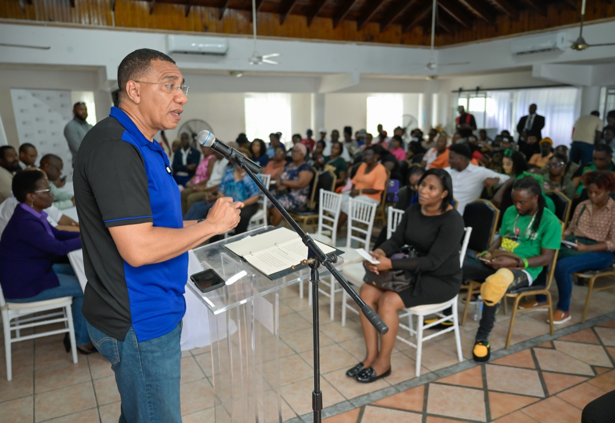 Prime Minister, Dr. the Hon. Andrew Holness (left) addresses a land title ceremony hosted by the Housing Agency of Jamaica (HAJ) at the Hotel Comingle in Savanna-la- Mar, Westmoreland on Friday ( July 18).