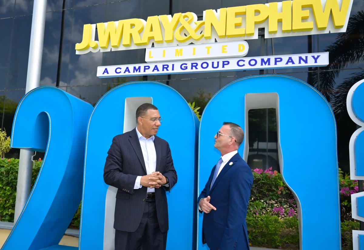 Prime Minister, Dr. the Most Hon. Andrew Holness (left), converses with J Wray and Nephew Limited Managing Director, Daniel Caron, during the company’s 200th anniversary celebrations, held at its corporate offices in New Kingston on Wednesday (July 23).