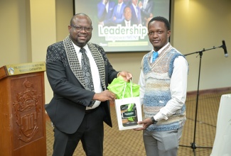 Director of Regional Educational Services, Ministry of Education, Skills, Youth and Information, Region One, Otis Brown (left), accepts a token from Senior Human Resource Officer in the Ministry, Jordan Wilson, during the National College for Education Leadership’s inaugural Leadership EmpowerMENt Session, held at the University of the West Indies Regional Headquarters in St. Andrew, on Thursday (July 31). 