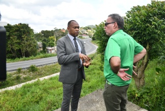 Minister of Science, Energy, Telecommunications and Transport, Hon. Daryl Vaz (right), in discussion with Transport Authority Managing Director, Ralston Smith, during a tour of the Christiana Transport Centre and adjoining lands being considered for the facility’s proposed expansion, in Manchester, on Wednesday (July 9).