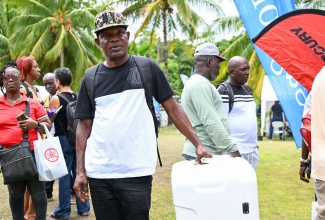 President of the Welcome Beach Fishermen’s Association, Shawn Thompson, poses with the new igloo he won during International Fisherman's Day celebration at Alligator Head Foundation in Portland, recently.