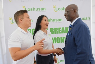 Minister of Local Government and Community Development, Hon. Desmond McKenzie (right), engages with Chief Executive Officer of Loshusan Supermarket, Bruce Loshusan (left), and Director of the business, Laura Loshusan-Arce. Occasion was the breaking of ground for the Loshusan New Kingston supermarket in St. Andrew on Tuesday (July 1).

