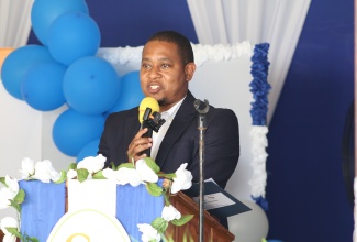 Minister of Agriculture, Fisheries and Mining, Hon. Floyd Green, delivers remarks during Wednesday’s (July 23) launch of the Sugar Company of Jamaica (SCJ) Holding Limited Regularisation Programme at Golden Grove Primary and Infant School in St. Thomas. 
