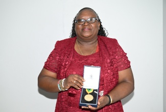 Vice Principal of Santa Cruz Primary and Infant School in St. Elizabeth, Rev. Dr. Sandra Lois Thompson, shows off her Prime Minister's Medal of Appreciation for Service to Education.


