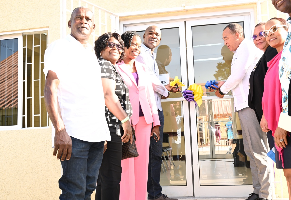 Health and Wellness Minister, Dr. the Hon. Christopher Tufton (fourth right) cuts the ribbon to mark the official opening and handover of the newly renovated sections of the Alexandria Community Hospital in St. Ann on Friday (July 18). He is joined by Member of Parliament for St. Ann South Western, Hon. Zavia Mayne (fourth left ) and other executives and administrators of the North East Regional Health Authority (NERHA).