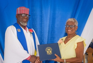 Jamaica Information Service (JIS) Senior Reporter, Garfield Angus (left), is presented with an honorary diploma by Chair of the José Martí Technical High School Board, Sandra Swyer-Watson. The presentation was made at the institution’s school-leaving ceremony on Wednesday (July 2).

