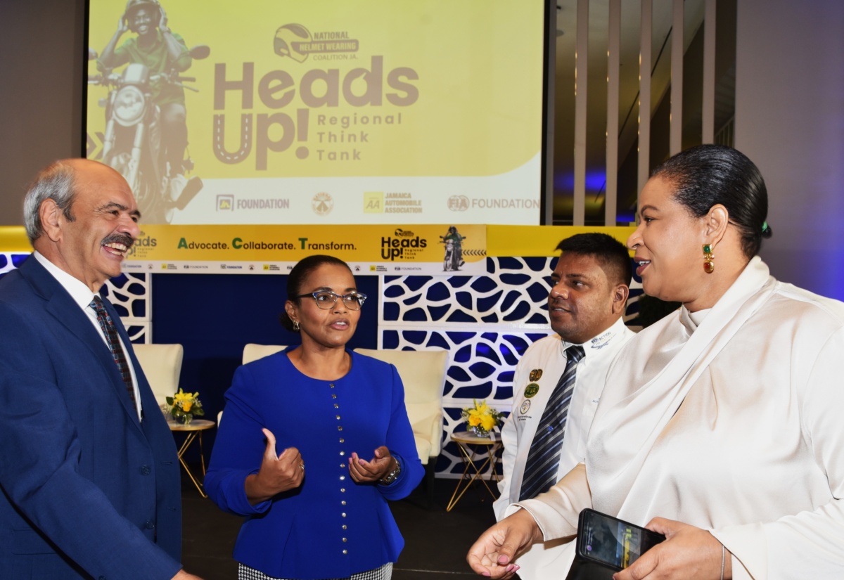 Technical Assistant in the Ministry of Science, Energy, Telecommunications and Transport, Donaree Muirhead (right), engages in discussion with (from left) President, Fédération Internationale de l