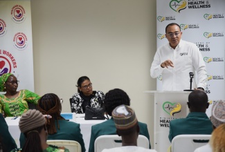 Minister of Health and Wellness, Dr. the Hon. Christopher Tufton, addresses an introduction and handover ceremony for nurses from the Nigeria Technical Aid Corps Programme on Monday (July 7) at the Ministry in New Kingston. Listening (from left) are Chargé d